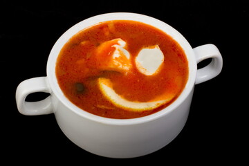 Meat Solyanka soup in a white tureen