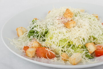 Classic Caesar salad on a white plate