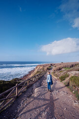 Fototapeta na wymiar Tourism concept. Young traveling woman enjoying ocean view.