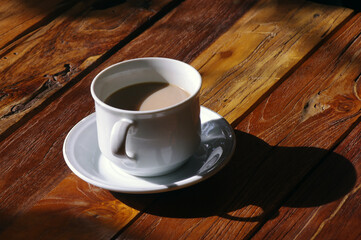 A cup of coffee on wooden table