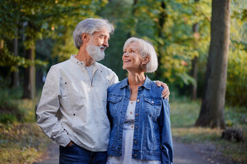 Senior family couple walking together at summer park.