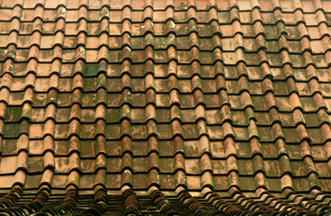Vintage multi colored clay tiled roof in Java Island, Indonesia.