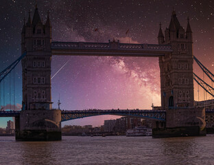 London, England, the tower bridge over Thames river under starry night sky