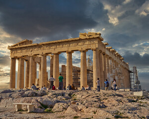 tourists admiring Parthenon antique temple and scenic sunset on Acropolis of Athens Greece