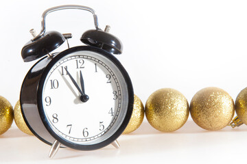 Vintage alarm clock showing five to twelve with Christmas. Happy New Year 2021!