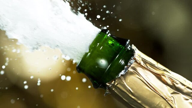 Super slow motion of Champagne explosion, opening champagne bottle closeup. Filmed on high speed cinema camera, 1000fps