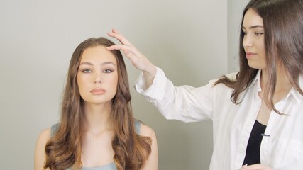 Beauty industry close up. Cosmetologist and client. Cute brunette with smooth healthy skin. Doctor...
