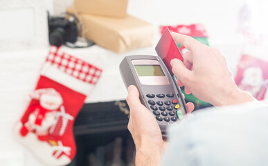 Payment on a trade through contactless card and NFC technology. Front view. Horizontal composition.