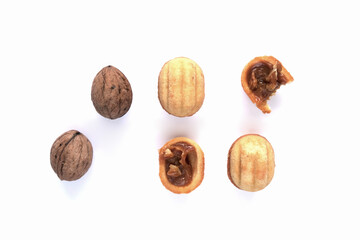 Creative mockup made of cookies in the shape of a nut and walnut. Flat lay. Food concept. Cookies on a white background.
