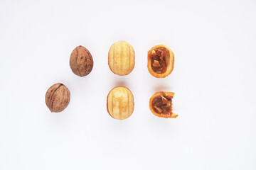 Creative mockup made of cookies in the shape of a nut and walnut. Flat lay. Food concept. Cookies on a white background.
