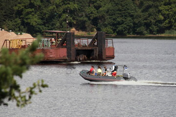 People in life jackets are floating fast on a RIB PVC inflatable motor boat with 90hp powerful...