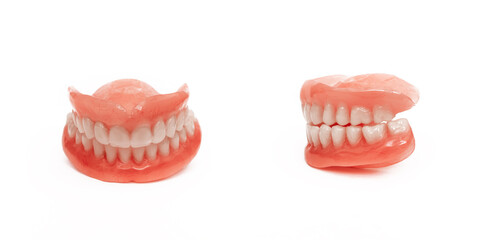 Full removable plastic denture of the jaws. Set of dentures on a white background. A side view of a...
