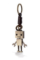 Detail shot of retro keychain made as bronze robot on coiled leather cord with bronze rings. The stylish keyring is isolated on the white background.