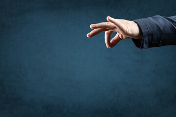 template image. man's hand holds an empty space with two fingers. manipulation concept. blue...