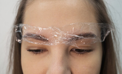 Women's eyebrows close-up, preparation for coloring.
