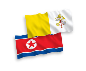 National vector fabric wave flags of North Korea and Vatican isolated on white background. 1 to 2 proportion.