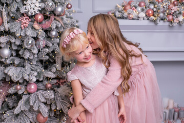 two girls hugging waiting for santa claus. Christmas days.