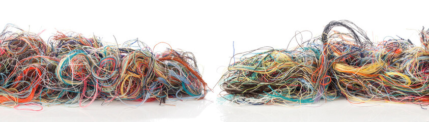 Colorful tangled threads isolated on white background. Closeup.
