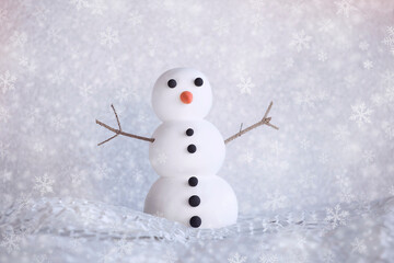 Cute snowman figure on winter frozen background with snowflakes. Mockup, artificial scene, greeting card, seasonal background. Winter snowing.
