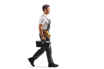 Repairman in a uniform walking and carrying a tool box