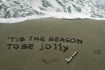 Fototapeta premium Line from Christmas carol on beach sand