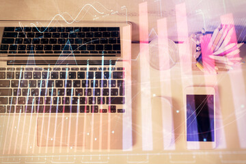 Multi exposure of forex graph drawing over desktop background with computer. Concept of financial analysis. Top view.