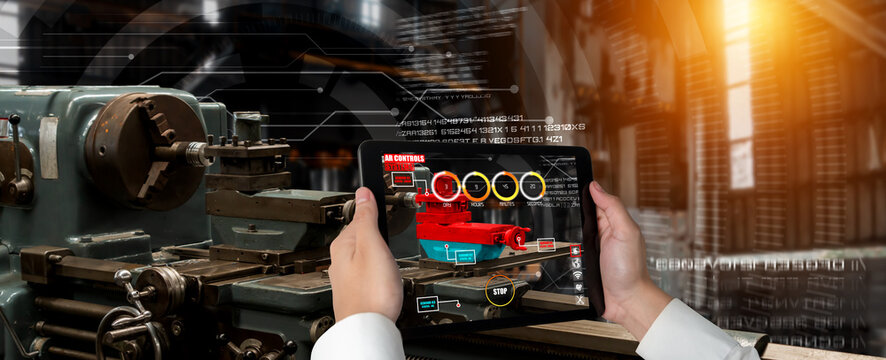Engineer use augmented reality software in smart factory production line with automated application . Futuristic machinery in working in concept of Industry 4.0 or 4th industrial revolution.