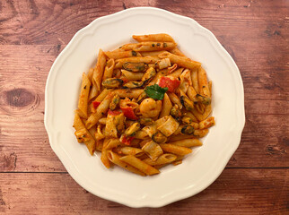 Seafood penne pasta, also know as pasta frutti di mare, in tomato sauce.