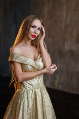Fototapeta premium woman in gold shiny New Year's dress
