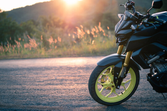 Motorcycle parking on the road, Vintage style with sunset light, copy spec for individual text, motorbike wit nature landscape