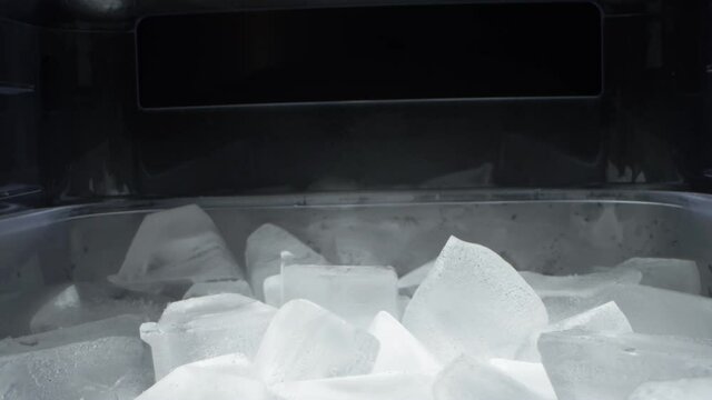 extremely close-up, detailed. ice cubes in a plastic transparent container.