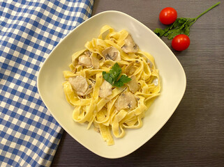 Creamy mushroom tagliatelle pasta. Vegetarian dish.