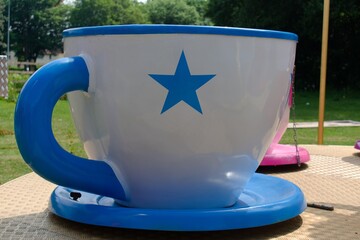 
Teacup ride at fair. Close up of Large blue and white teacup.