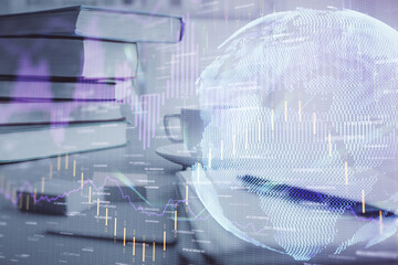 Double exposure of financial chart drawing and desktop with coffee and items on table background. Concept of forex market trading