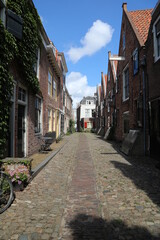 Fototapeta na wymiar street in the town with lovely brick houses, middelburg, netherlands