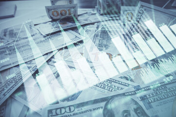 Multi exposure of forex chart drawing over us dollars bill background. Concept of financial success...