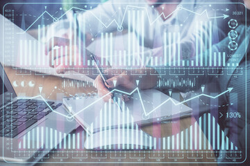 Double exposure of forex chart drawing over people taking notes background. Concept of financial analysis