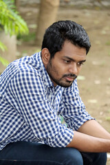 Young Handsome  Looking  down  in the outdoor 