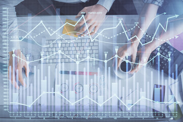 Double exposure of man and woman working together and financial chart hologram drawing. market analysis concept. Computer background. Top View.