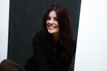 Portrait of a young happy woman isolated on a blackboard.