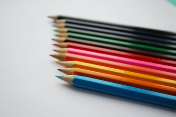 Wooden colored pencils isolated on white background. Creation. Place for text.	