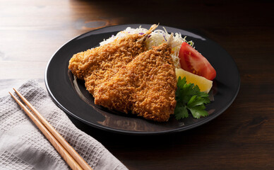 Fried horse mackerel served on a plate on a wooden background