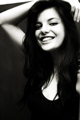 Fototapeta na wymiar Portrait of a young happy woman isolated on a blackboard.