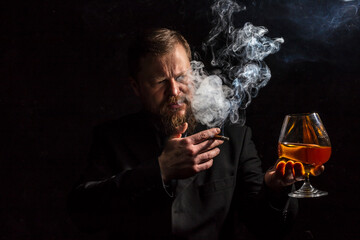 Solid confident bearded man in suit with glass of whisky and cigar with fume