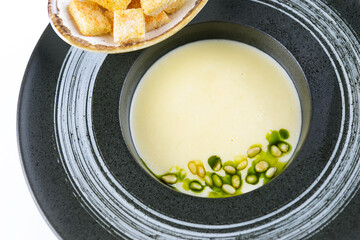 Creamy soup with pine nuts and croutons