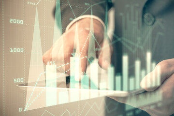 Multi exposure of man's hands holding and using a phone and financial chart drawing. Market analysis concept.