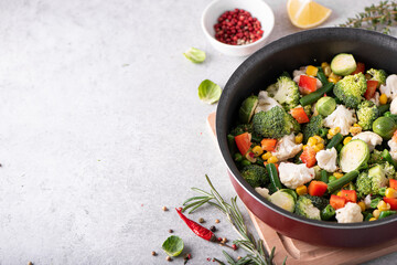 fresh vegetables - broccoli, green beans, peas, cauliflower stewed in a saucepan