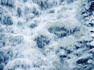 Cascades of the waterfall in winter close-up. Frozen waterfall