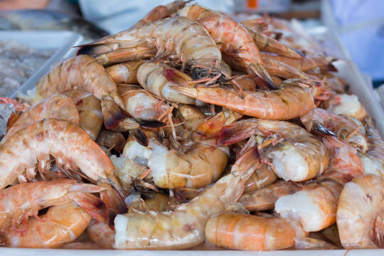 Fresh prawns without the head on a tray in the fish market. Food very widespread in coastal cities.Raw Shrimp.