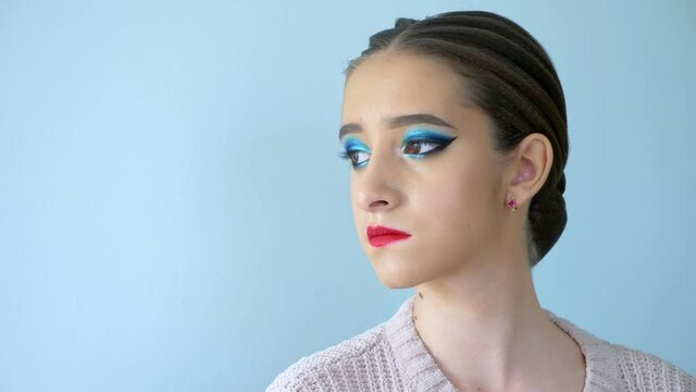portrait of a beautiful girl model with bright makeup. emotion of arrogance. copy space